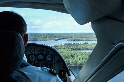 Rear view of pilot flying air plane