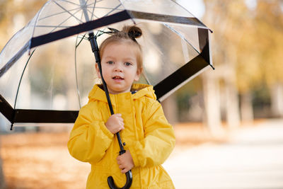 Young woman holding umbrella