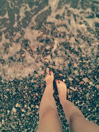 Low section of woman legs on beach