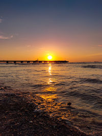 Scenic view of sea against romantic sky at sunset