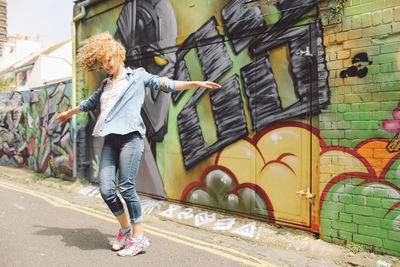 Woman jumping on city street