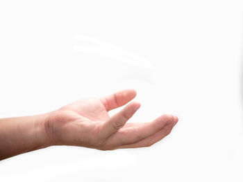 Close-up of hand holding hands over white background