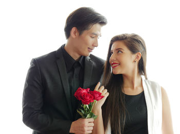 Young couple holding rose
