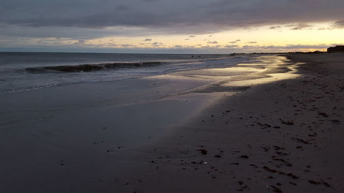 Scenic view of beach against sky during sunset