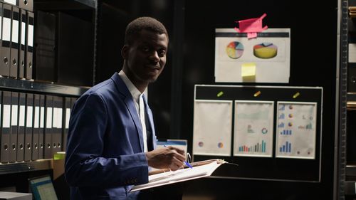 Side view of young man using laptop in classroom