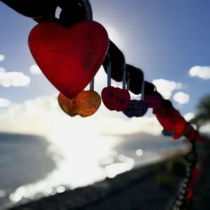 Low angle view of red lanterns hanging against sky