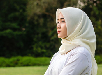 Portrait of a young woman looking away