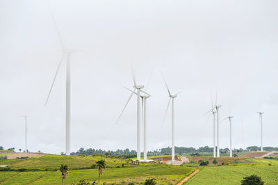 Windmill on field against sky