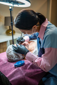 Side view of doctor examining patient at clinic