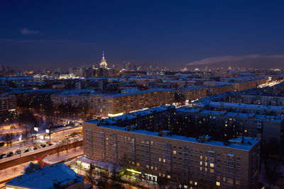 Illuminated buildings against sky at night in city