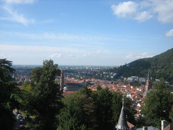 High angle view of trees and cityscape against sky