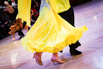 Low section of people dancing on floor