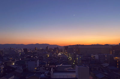 High angle view of illuminated buildings against sky during sunset