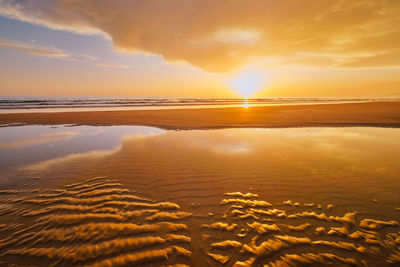 Atlantic ocean sunset with surging waves at fonte da telha beach, portugal
