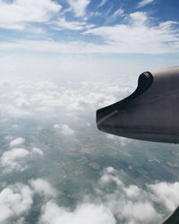 Aerial view of aircraft wing against sky