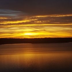 Scenic view of sea against romantic sky at sunset