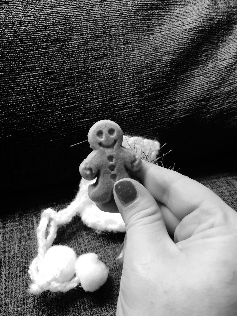 CLOSE-UP OF HAND HOLDING TOY ON FINGER