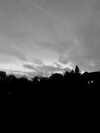 Silhouette trees on landscape against sky