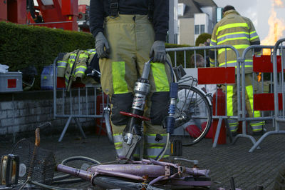 Low section of man standing on bicycle