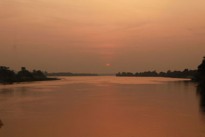 Scenic view of sea against orange sky