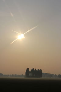 Scenic view of field against sky during sunset