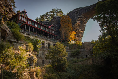 Low angle view of historical building against sky and natural arch