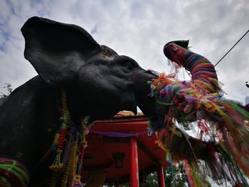 Low angle view of statue against cloudy sky