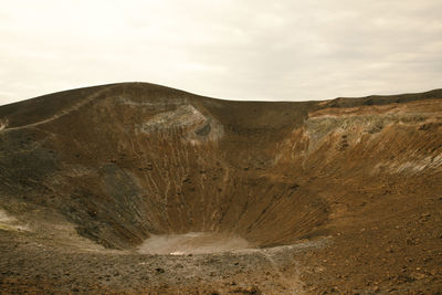 Scenic view of arid landscape against sky