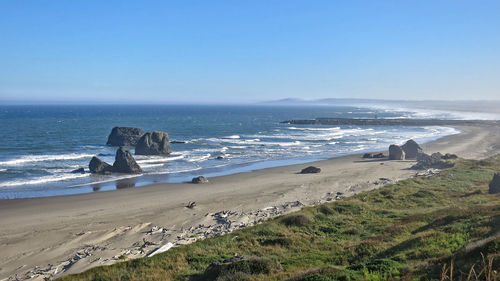 Scenic view of beach against clear sky