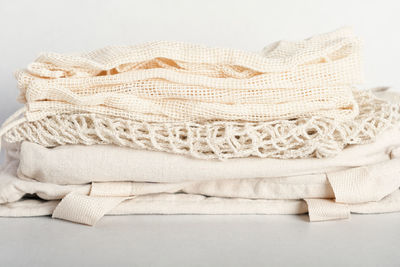 Stack of eco friendly bags on a grey background. string and canvas bags made of cotton threads. 