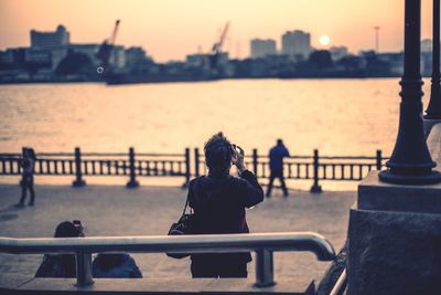 People in river at sunset