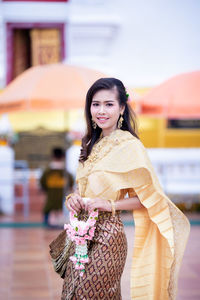 Portrait of a smiling young woman standing outdoors