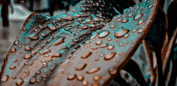 Close-up of water drops on rusty metal