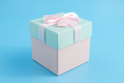 Close-up of gift box against blue background