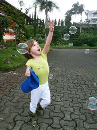 Boy playing with bubbles in park