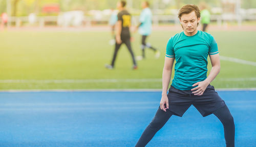 Young man exercising at stadium