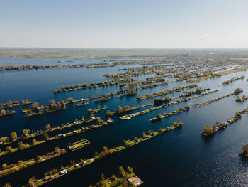 High angle view of cityscape by sea against sky