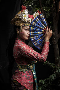 Portrait of woman wearing traditional clothing standing outdoors