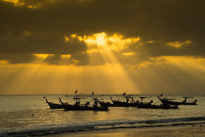 Silhouette ship on sea against sky during sunset