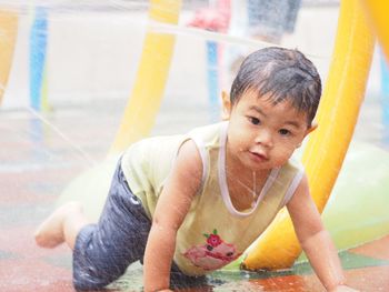 Portrait of cute boy enjoying at water park