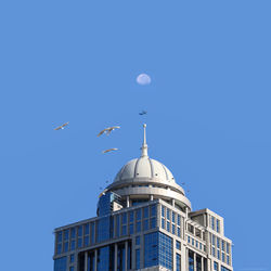 Low angle view of building against clear blue sky