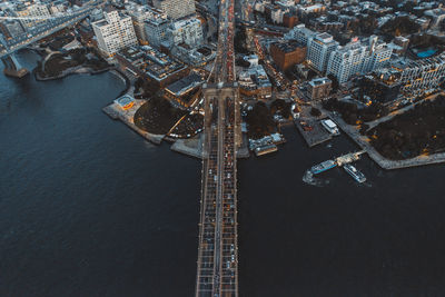 Aerial view of illuminated bridge over river in city