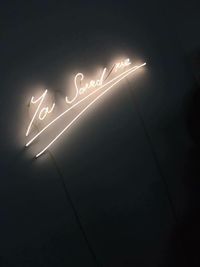 Low angle view of illuminated text at night