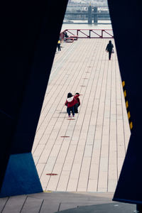 High angle view of people walking on footpath