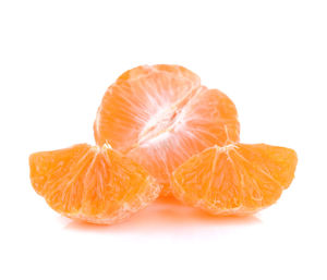 Close-up of orange slice against white background