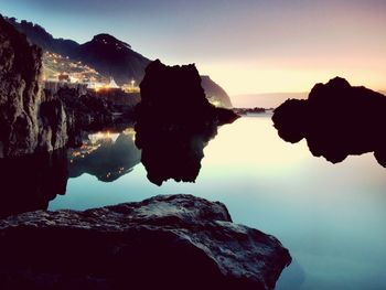 Scenic view of lake against sky during sunset