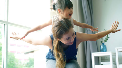 Mother and daughter exercising at home