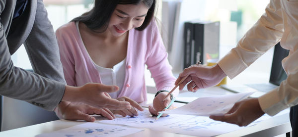 Midsection of woman working on table