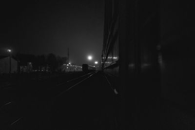 Train on illuminated street at night