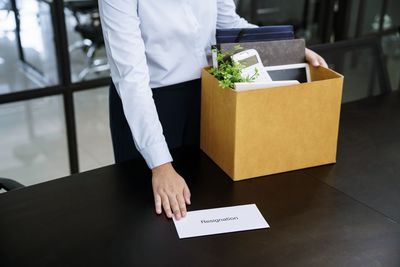 Midsection of woman holding cardboard box